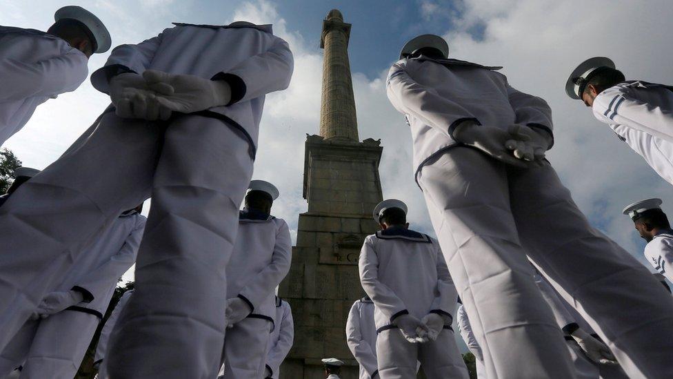 Sri Lankan Navy soldiers stand in front of the War Memorial, during an event marking Remembrance Day, also known as Poppy Day, to commemorate the sacrifices of members of the armed forces and of civilians in times of war, in Colombo, Sri Lanka November 11, 2017