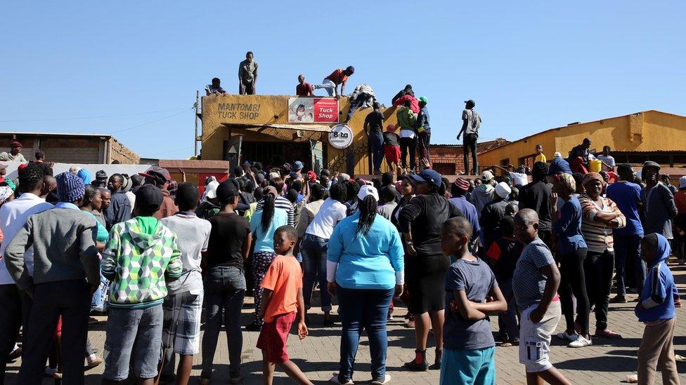 People looting a shop near Pretoria, South Africa