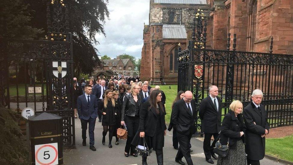 People leaving the funeral