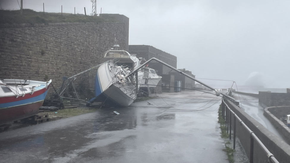 Yacht blown over in Braye Harbour, Alderney