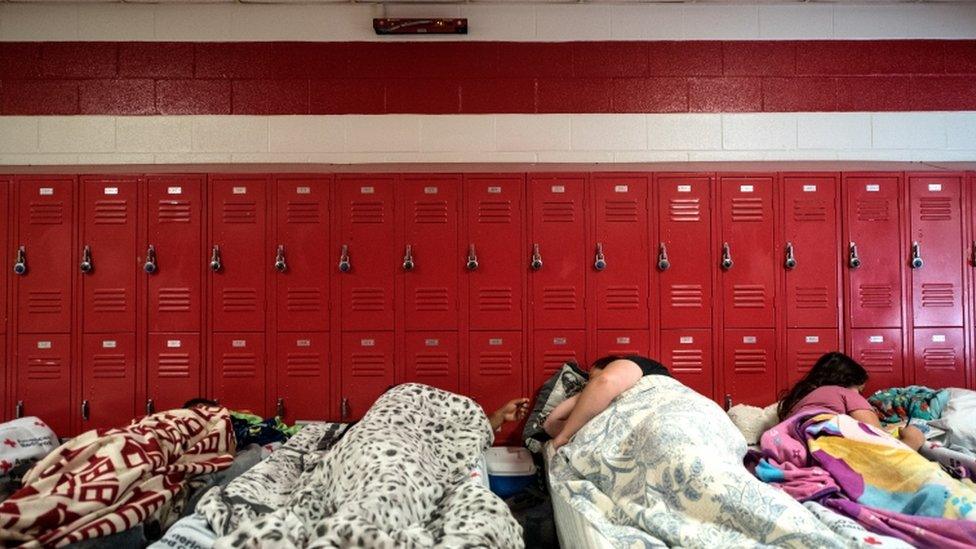 Some families have spent the night in schools, which have been turned into evacuation shelters ahead of Hurricane Florence's arrival