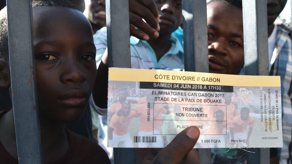 A football fan shows his ticket for the match outside the stade de la Paix in Bouake on June 3, 2016 on the eve of their 2017 African Cup of Nations qualifiers football match between Ivory Coast and Gabon