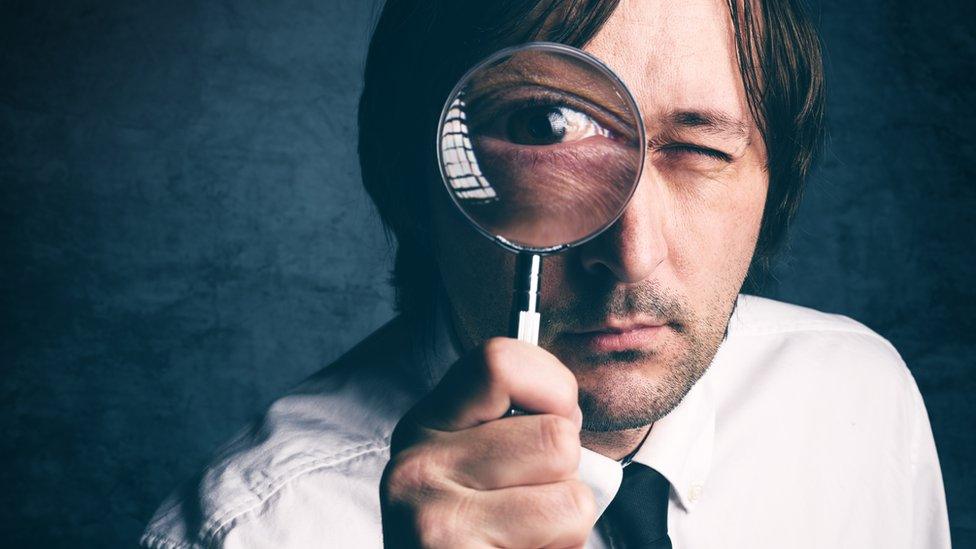 sleuth with magnifying glass