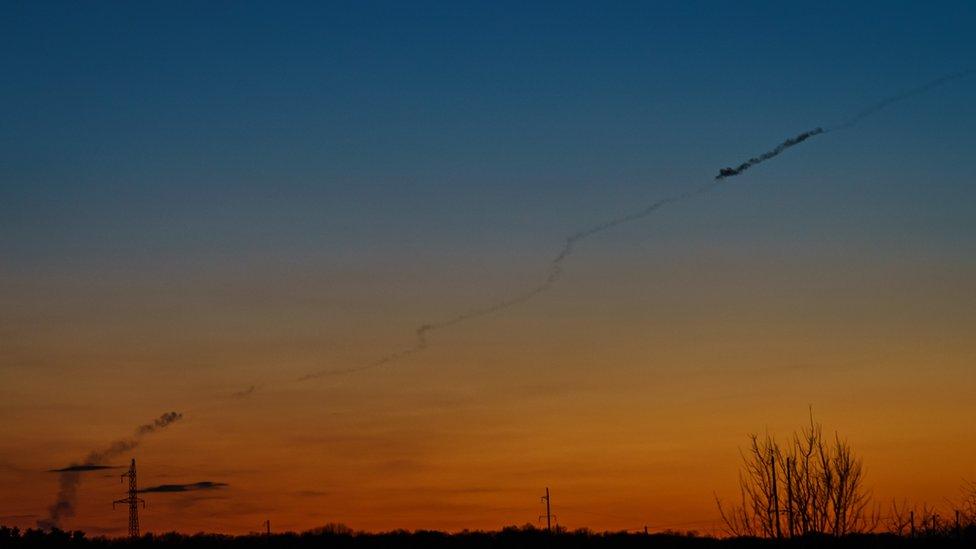 A smoke trail from a rocket launch could be seen in the evening sky in Baryshivka, Ukraine, 11 March 2022.