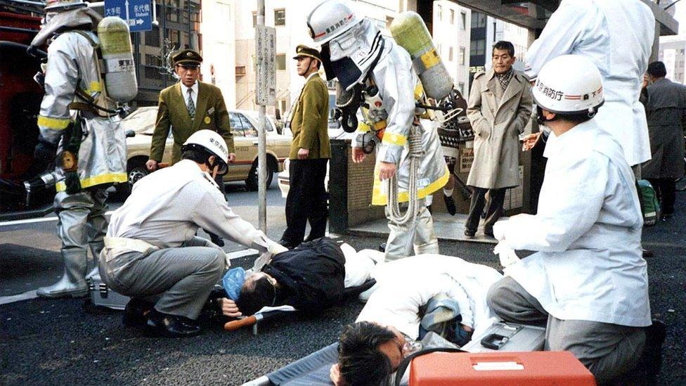 Passengers rescued from the station lie on the ground.