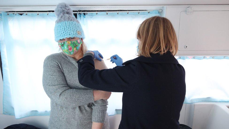 Woman being vaccinated at a mobile centre in south-east London