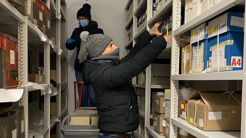 Conservator Alex Koukos and archivist Lindsey Sutton surveying the E. Chambre Hardman collection