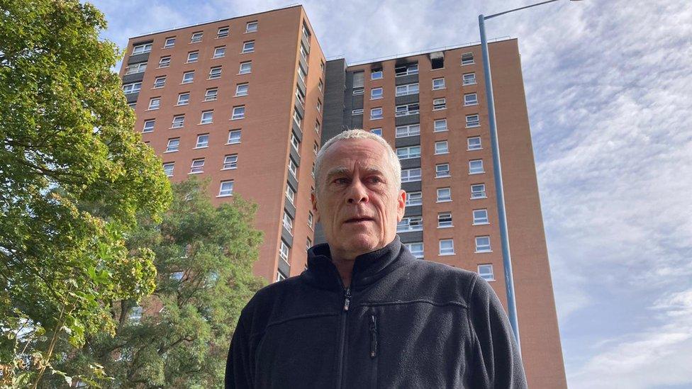 Mark Barrett outside the block of flats