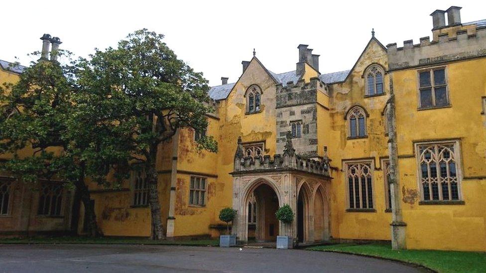 The main entrance to Ashton Court Mansion, with trees either side