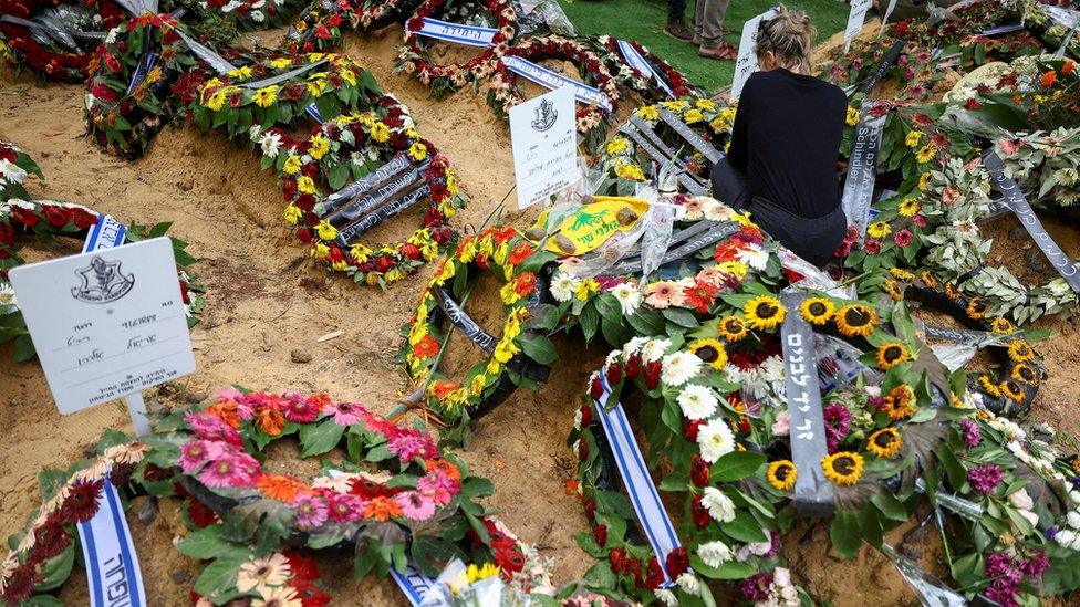 A woman mourns Roy Joseph Levy, an Israeli soldier who was killed during Hamas's attacks on southern Israel on 7 October, after his funeral at Mount Herzl military cemetery in Jerusalem (15 October 2023)