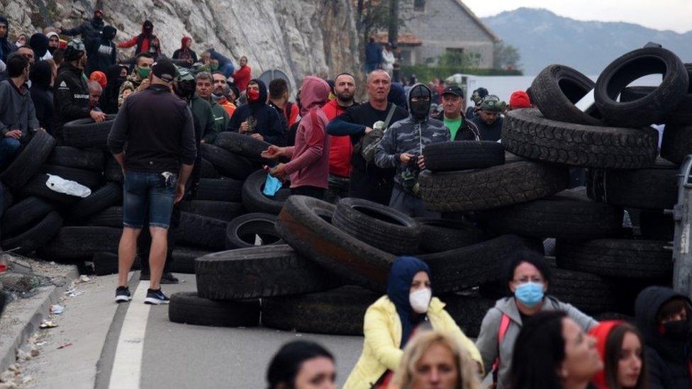 Protesters man tyres at a road block in Montenegro