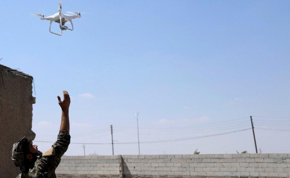 A Syrian Democratic Forces soldier releases a drone, 18 June