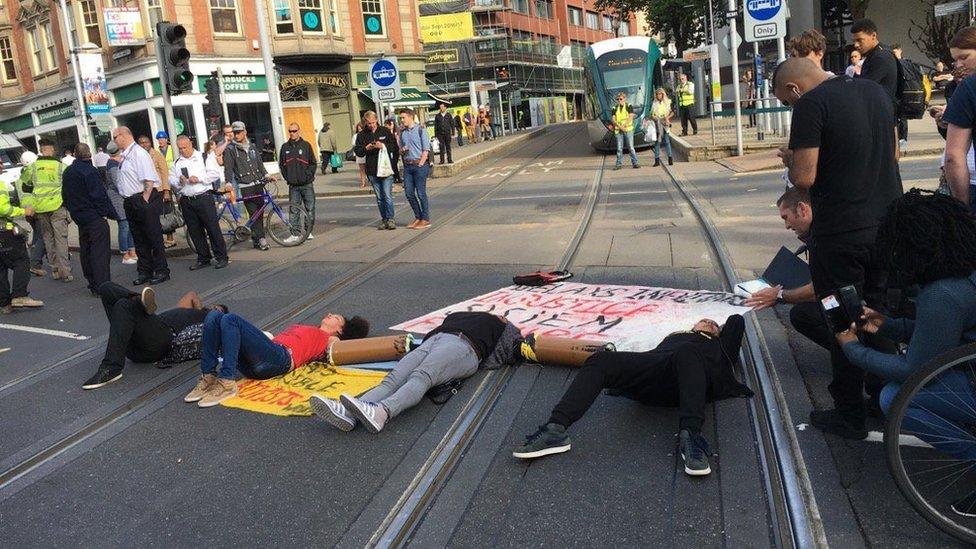 Protestors lying down in the road