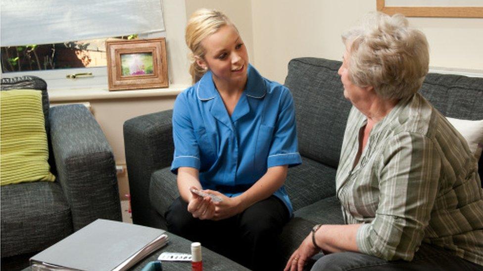 Medical staff member chats to patient