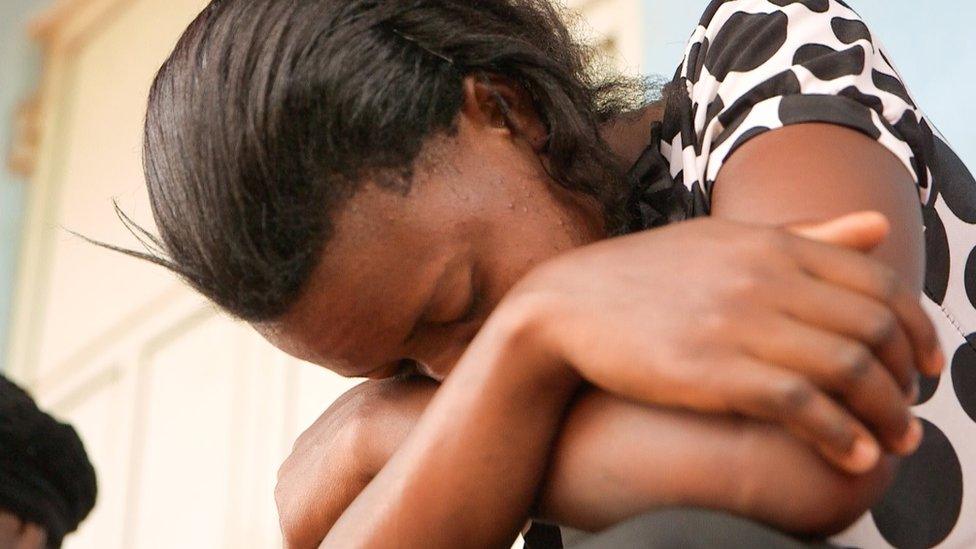 A patient puts her head in her hands