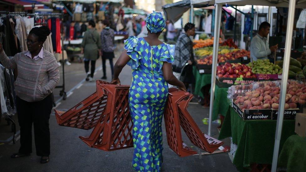 A trader carries trays at East Street Market in south London on September 2, 2017