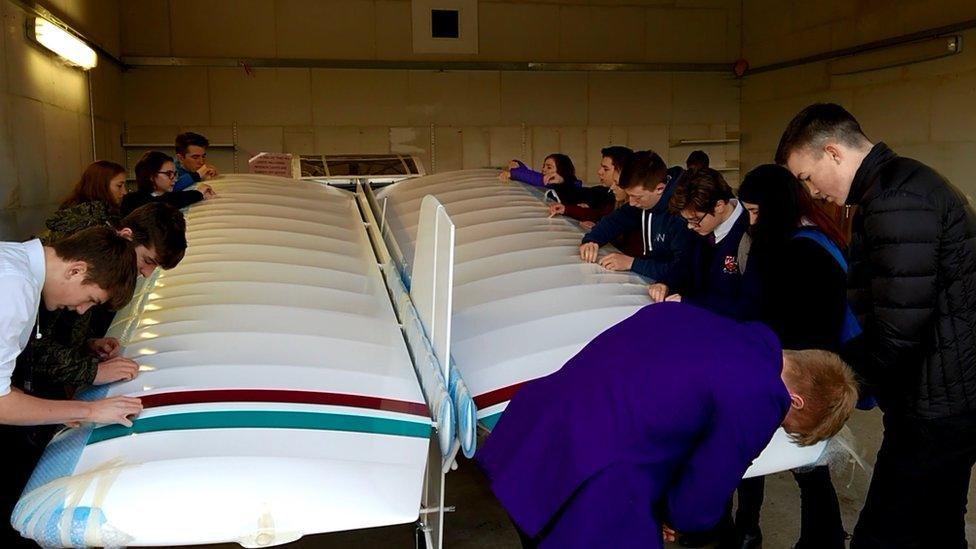 Pupils unwrapping the wings