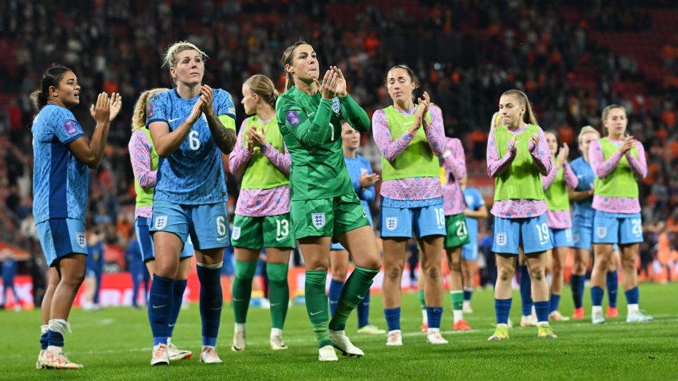 England players looking disappointed and clapping fans after the game