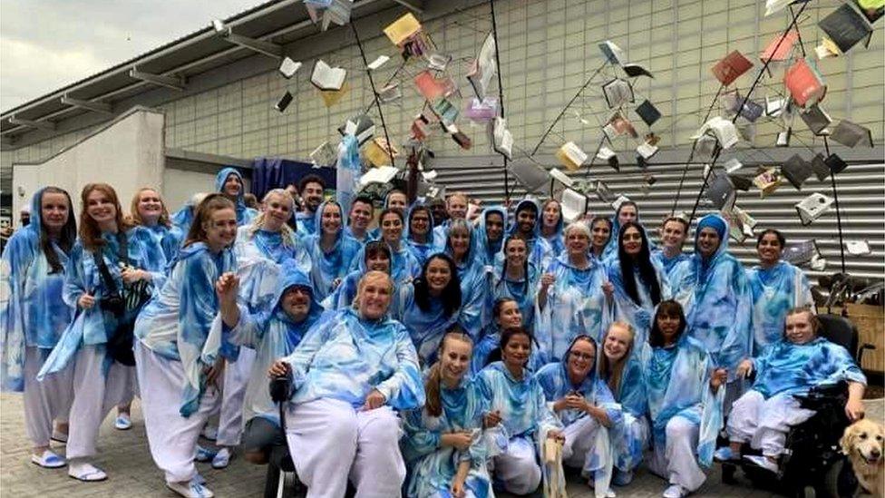 Leanna Horne, pictured right has a photo taken alongside all the performers from the book chorus who took part in the opening of the Commonwealth Games