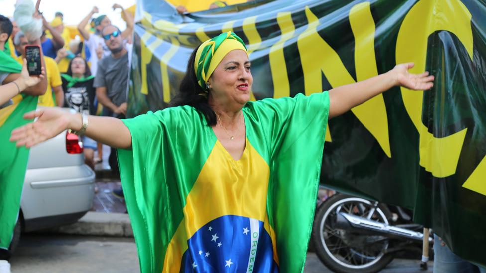 A woman cheers at a Jair Bolsonaro rally