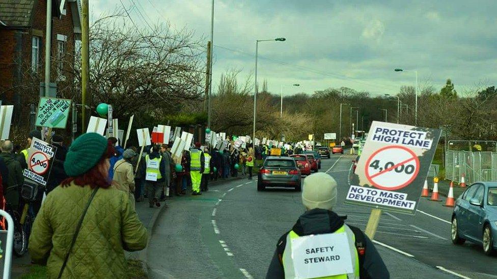 protesters march down road