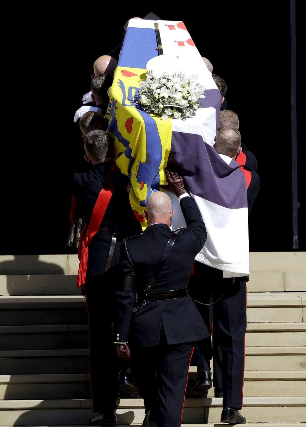 The Duke of Edinburgh's coffin, covered with His Royal Highness's Personal Standard is carried into St George's Chapel, Windsor Castle, Berkshire, during the funeral of the Duke of Edinburgh.