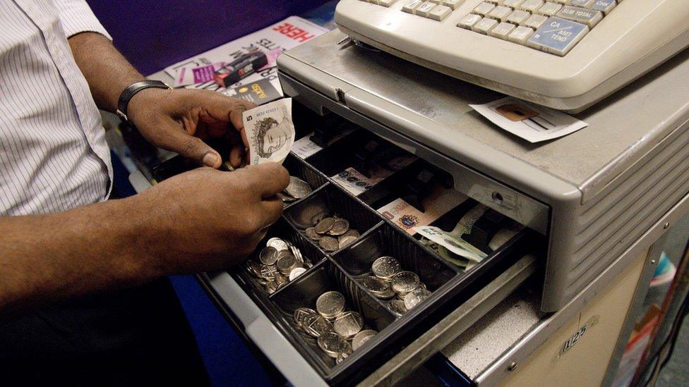 Generic man working on cash register