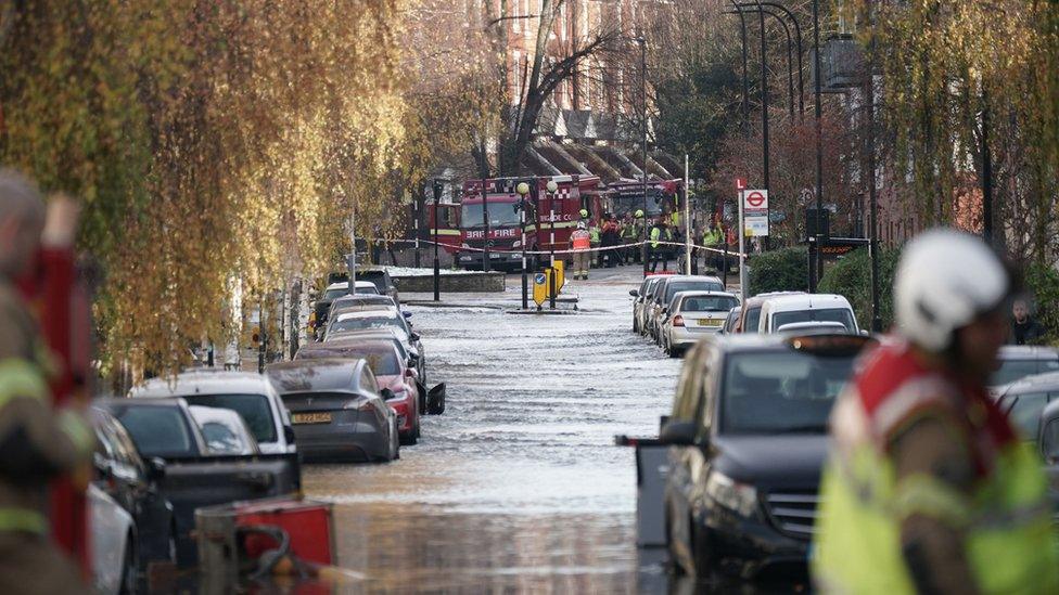 Flooded street and fire crews at the scene