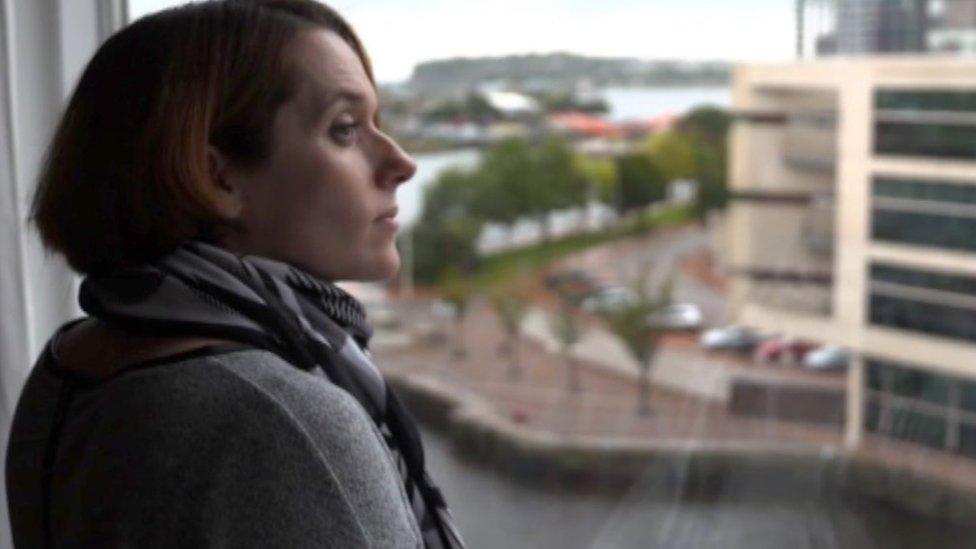 woman looking out of window