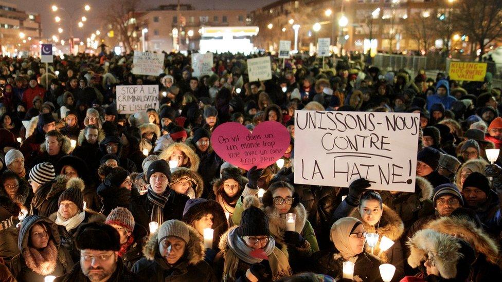 A large crowd stretching beyond view attends the vigil in Quebec