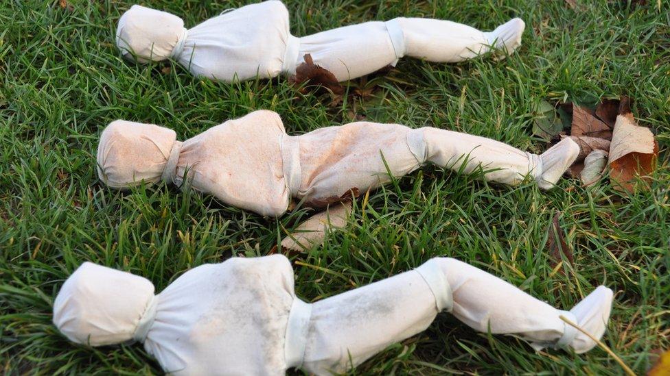 Shrouded figures on College Green