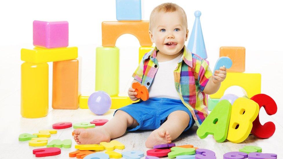 toddler with alphabet blocks