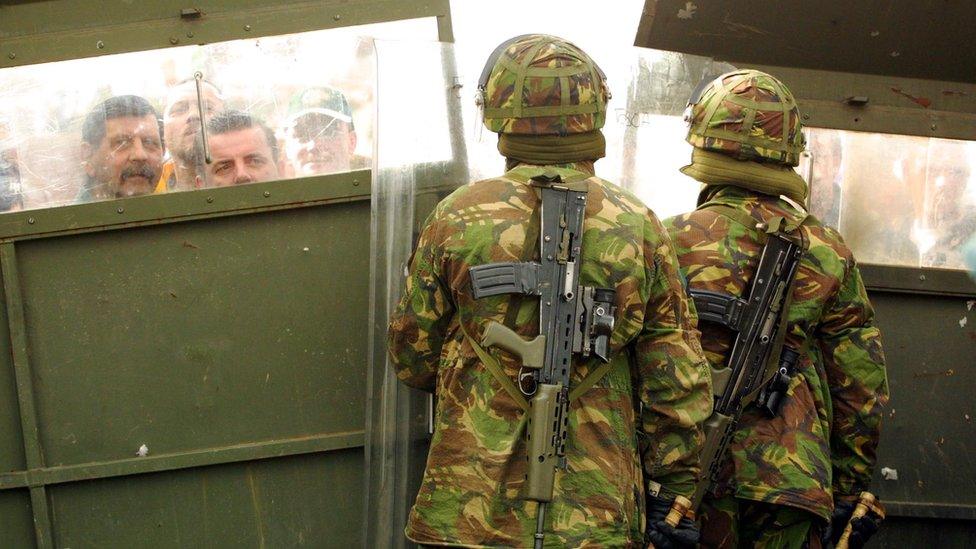 Soldiers at a barrier on the Ardoyne Road during the Holy Cross dispute in Belfast on 6 September 2001