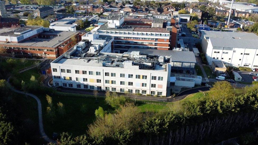 Kettering General Hospital site from the air showing multi-storey concrete buildings