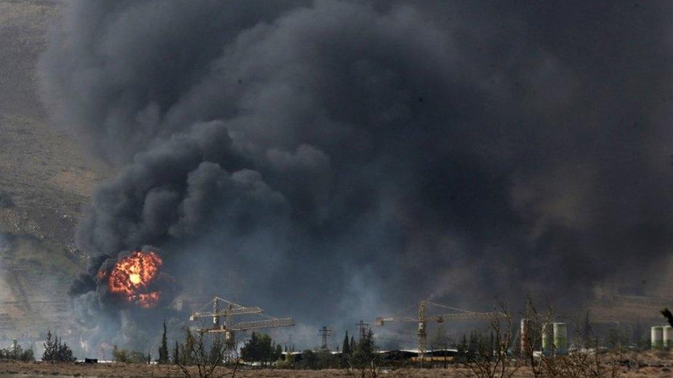 Smoke rises from what activists said was a military position of forces loyal to Syria's President Bashar al-Assad after clashes with Army of Islam fighters near the town of Douma (13 September 2015)