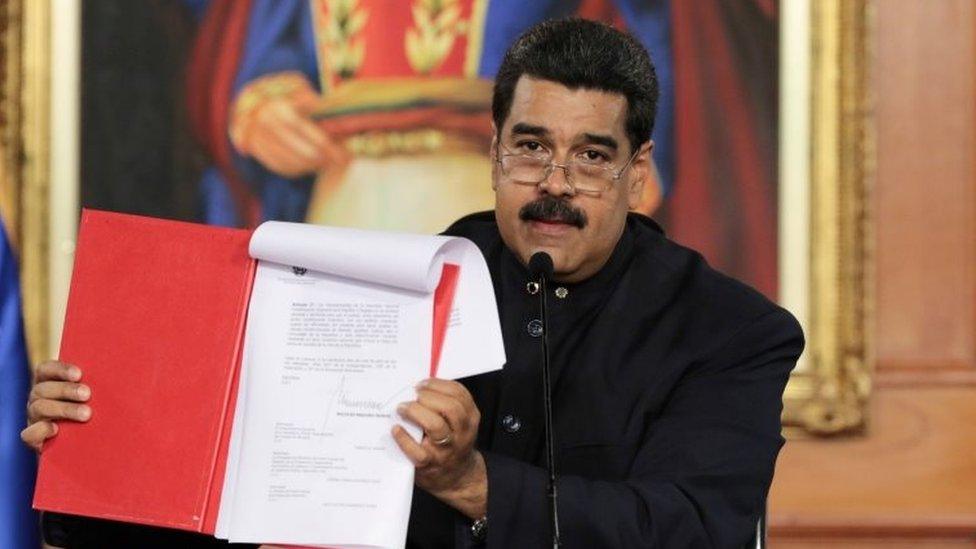 Venezuela's President Nicolas Maduro holds a document as he speaks during a ceremony at Miraflores Palace in Caracas, Venezuela May 1, 2017.