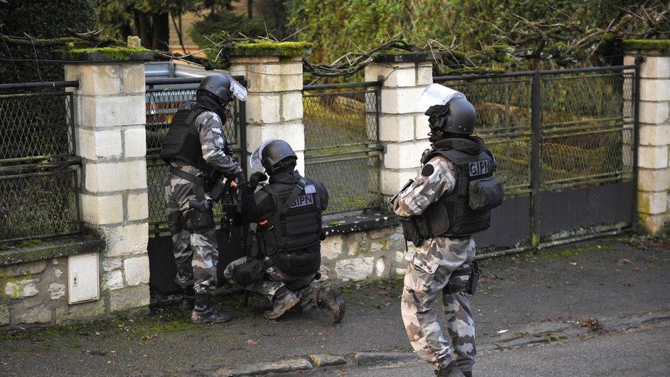 Members of the GIPN and RAID, French police special forces, walk in Corcy, northern France