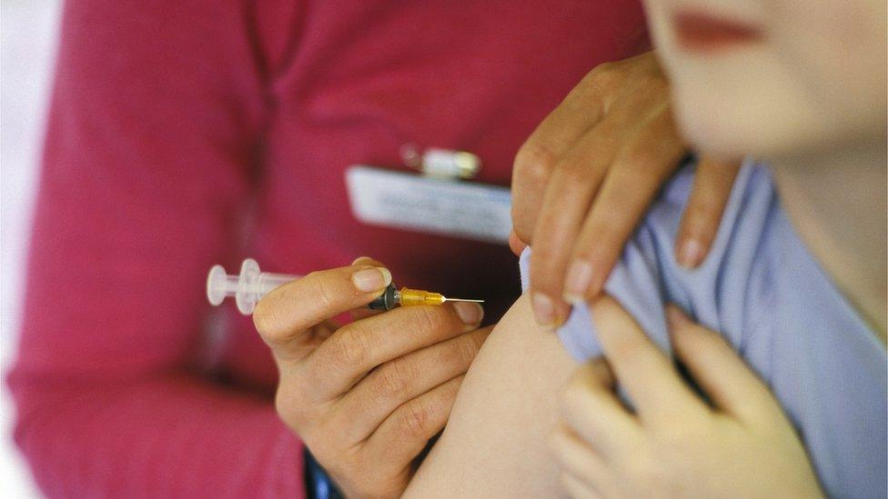 A child receives a vaccine