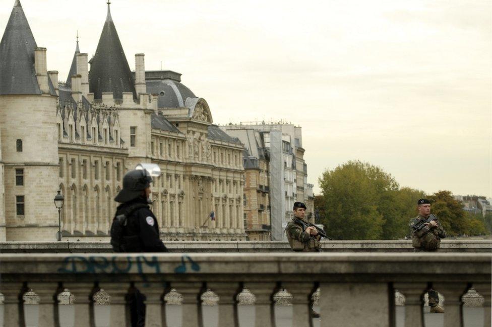 Military forces patrol near Paris police headquarters.