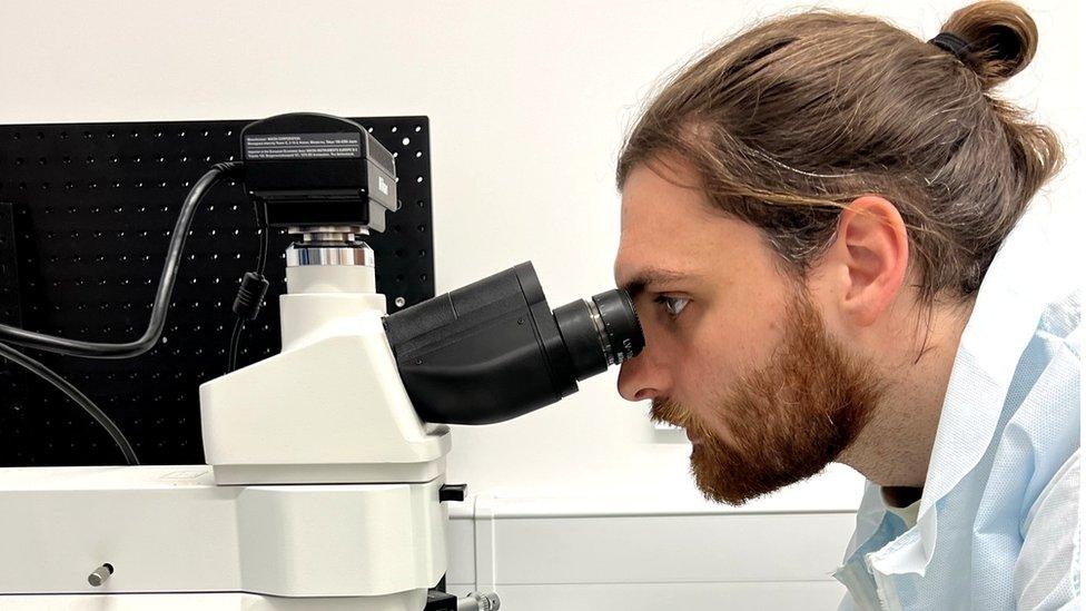 Lewis Fish, Head of Product at Opsydia, examining diamond