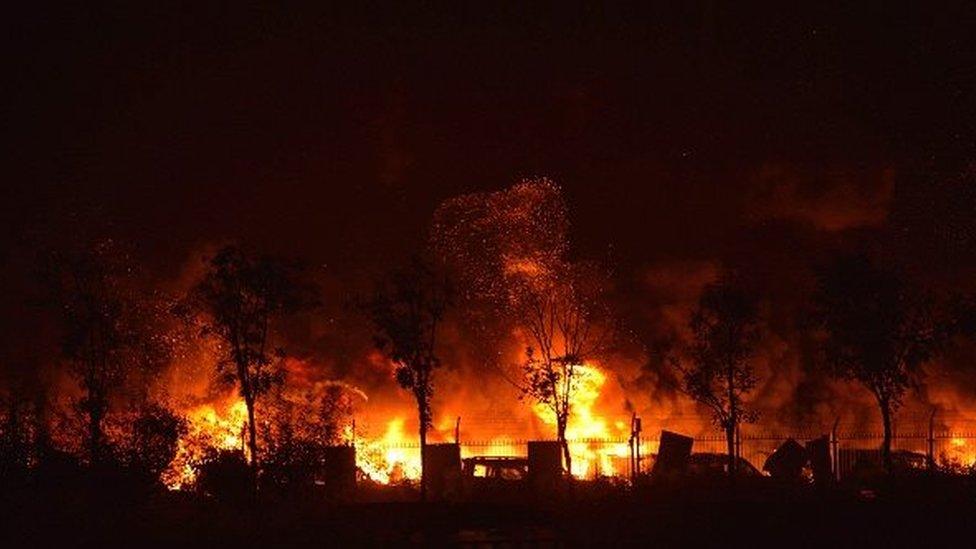 Flames and smoke rise from the site of a series of explosions in Tianjin early on August 13, 2015.