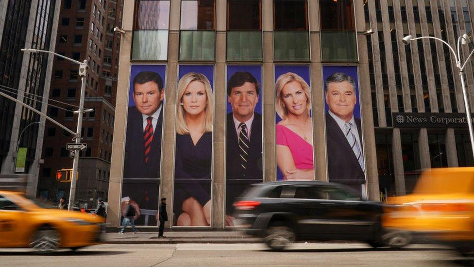 Posters of Fox News anchors outside the News Corporation offices in New York