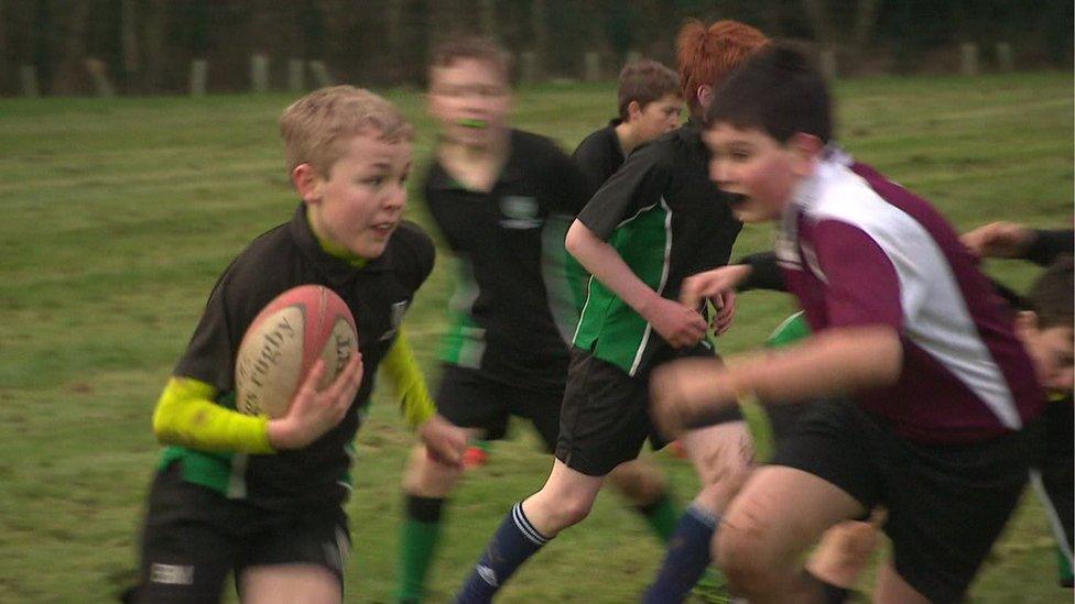 Schoolchildren playing rugby