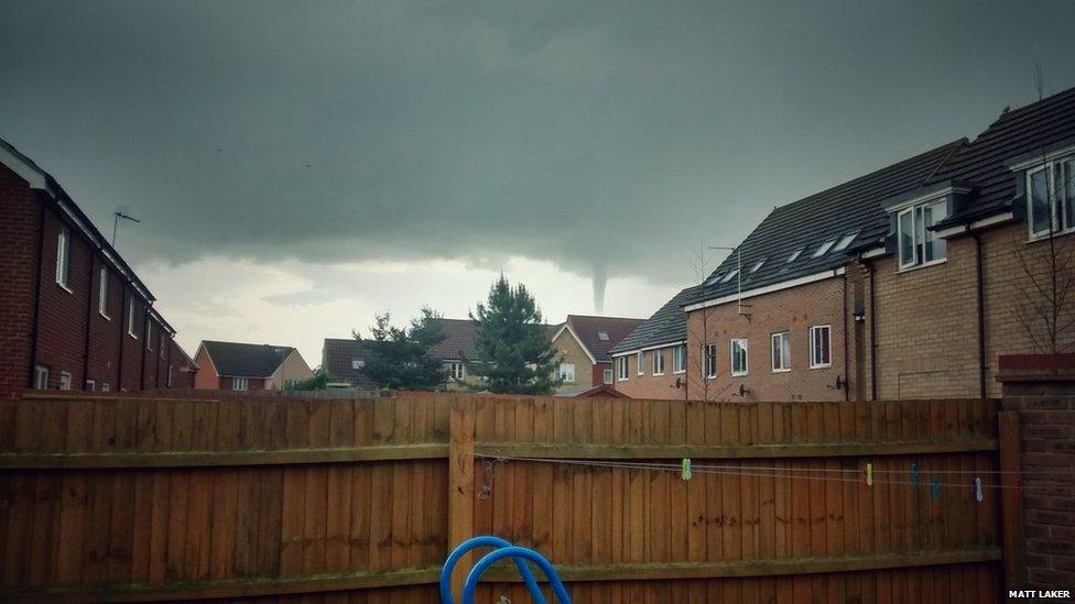 Funnel cloud over houses