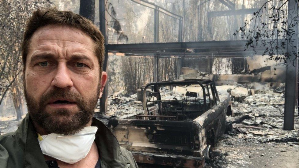 Gerard Butler in front of his fire-ravaged home