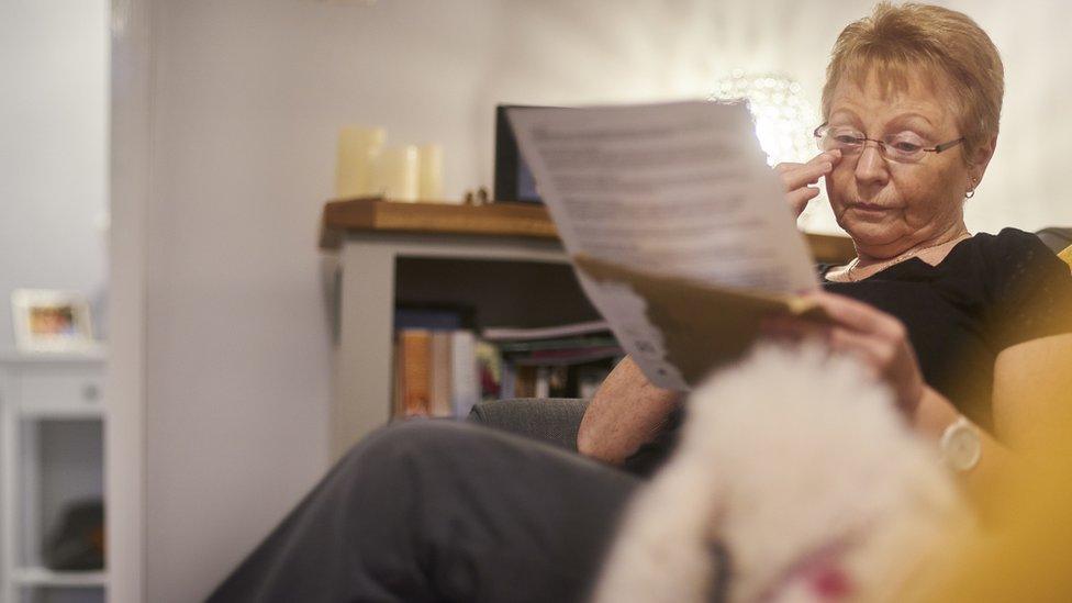 A woman getting emotional as she reads letter