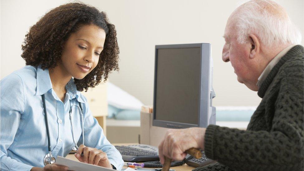 GP talking to older male patient