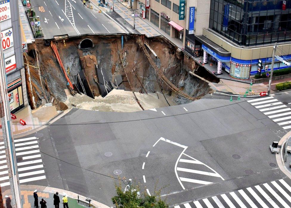 A huge sinkhole is seen at an intersection near Hakata station in Fukuoka, Japan, 8 November 2016