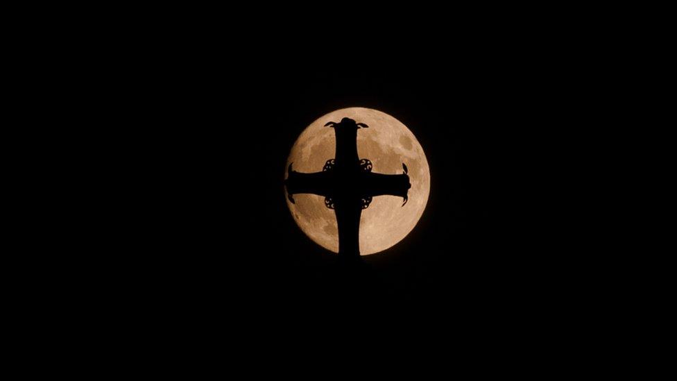 The moon behind St Paul's Cathedral