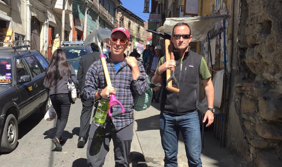 Dan holds a shovel and Isaac holds an ice axe in Laz Paz, Bolivia